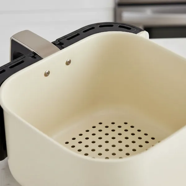 Close-up of a ceramic-coated air fryer basket, highlighting its non-stick and healthy cooking surface.
